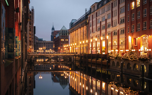 A city with buildings and a canal at night screenshot 1