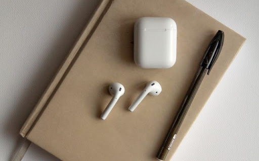 AirPods 2 Resting on a Notebook Beside a Pen screenshot 1