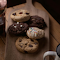 An Assortment of Cookies on a Wooden Chopping Board logo