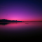 captures a stunning purple sunset over the ocean logo