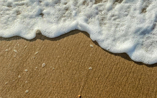 Close-up of a Foamy Wave on the Shore screenshot 1
