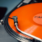 Close-up Photo of an Orange Vinyl Record logo