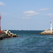 Coastal Harbor Entrance with Twin Lighthouses logo
