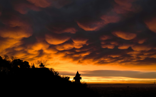 Dramatic Sunset Silhouette Over City Skyline screenshot 1