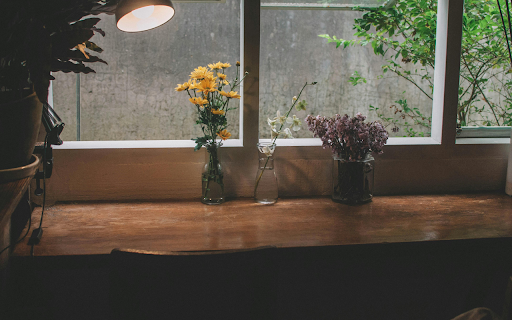 Flowers in vases with burning table lamp on windowsill screenshot 1