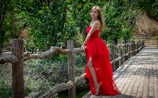 Girl in red dress next to wooden fence screenshot 1