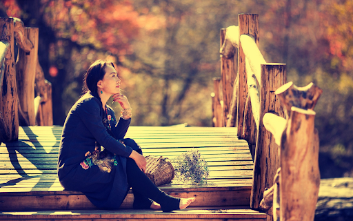 Girl sitting on wooden bridge screenshot 1