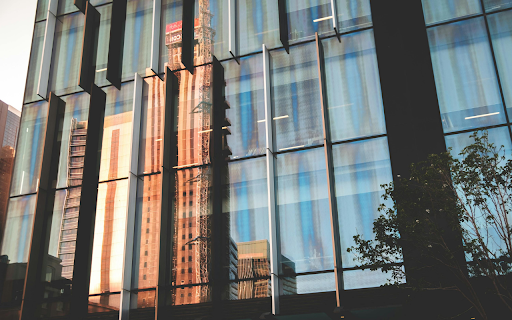 Modern facade of building reflecting street of city screenshot 1