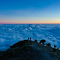 panoramic sea of clouds atop a mountain peak logo