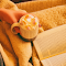 Person Holding Mug Filled With Pastry Beside Open-book logo
