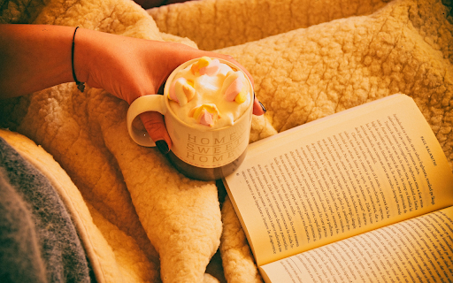 Person Holding Mug Filled With Pastry Beside Open-book screenshot 1