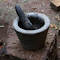 Pestle and stone mortar logo