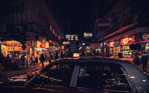 Photo of Taxi Near Buildings During Nighttime screenshot 1