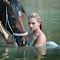 Precious horses bathe in the river logo
