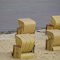 Rattan chairs on the beach logo