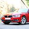 Red BMW 320i GT on the Road logo