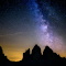 Silhouette Photography of Rocky Mountains Under Starry Sky logo