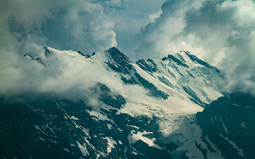 Snow Covered Mountain Under Cloudy Sky screenshot 1