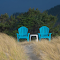 Two Wooden Chairs on the Grassland logo