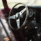 Vintage Car Interior with Steering Wheel and Dashboard logo