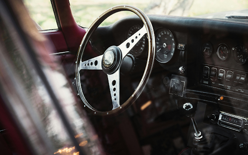 Vintage Car Interior with Steering Wheel and Dashboard screenshot 1