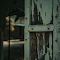 Wooden Door with Peeling Paint of an Abandoned Building logo