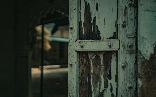 Wooden Door with Peeling Paint of an Abandoned Building screenshot 1